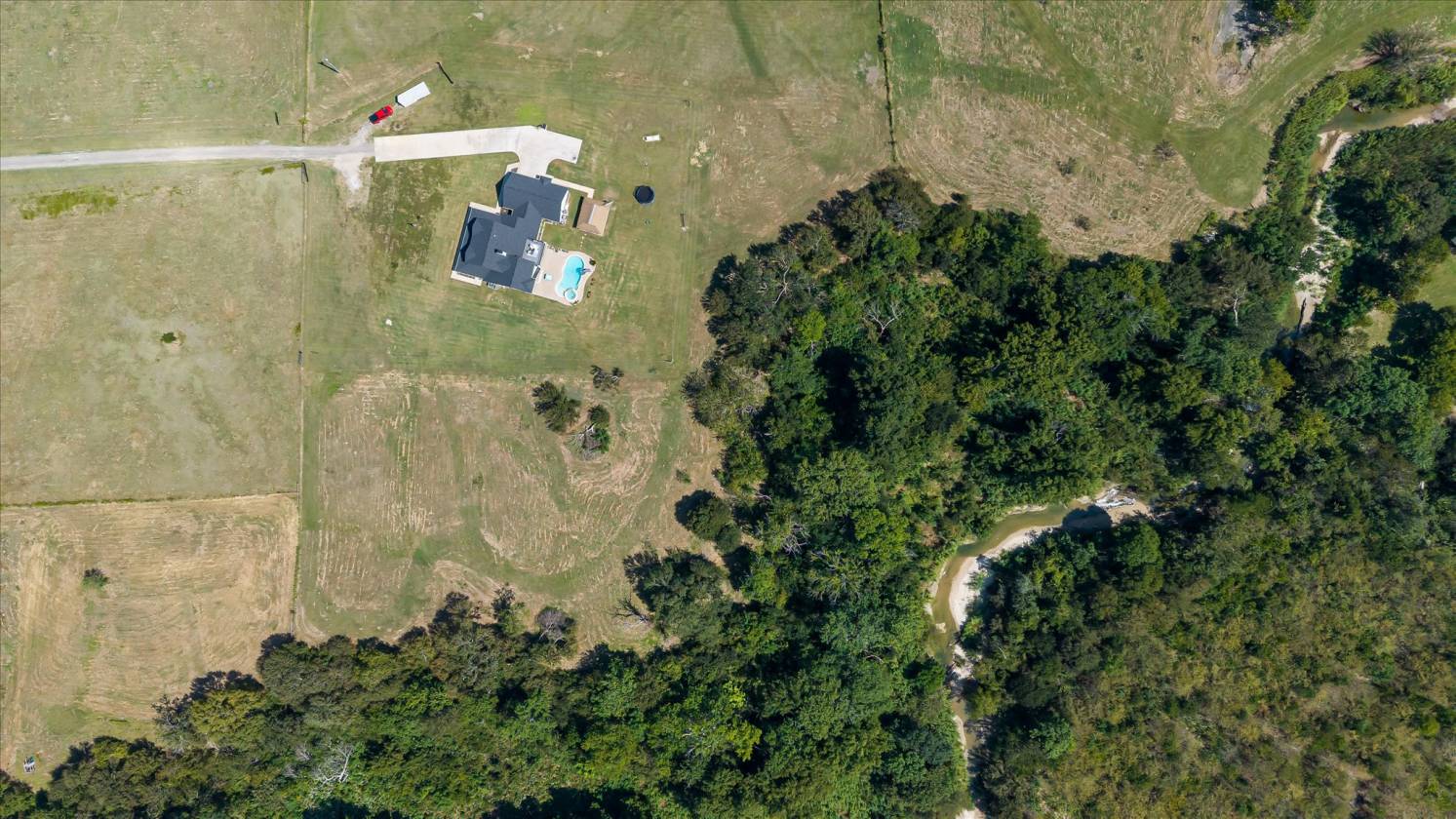 Gorgeous Farmhouse on 38+ Acres w/ Creek and Pond - photo 2
