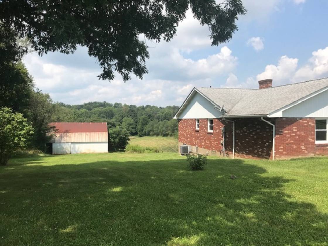 Updated brick ranch on 5 acres.Large horse barn with 6