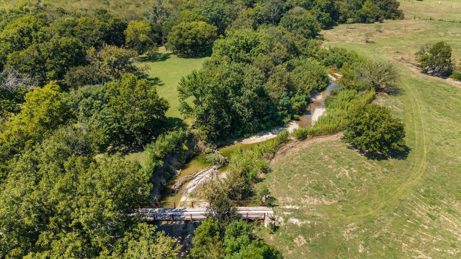Gorgeous Farmhouse on 38+ Acres w/ Creek and Pond - photo 7